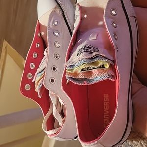 Converse white with multicolor tongues.